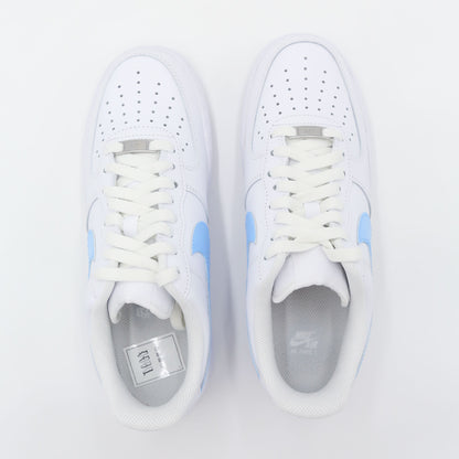 Nike Air Force 1 Custom blanche avec swoosh bleu ciel, design moderne et épuré pour un style unique. Sneakers customisées offrant confort, durabilité et polyvalence, idéales pour les tenues streetwear et casual.